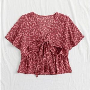 Red blouse with white flowers. Never been worn. Size large, fits medium-large